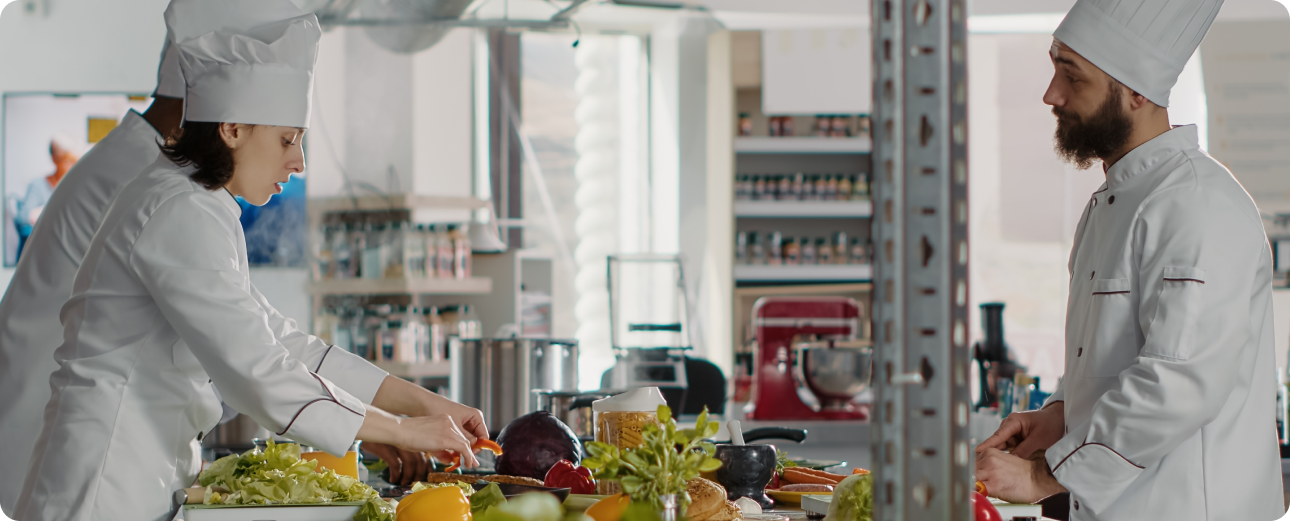 Commercial kitchen staff preparing food, representing operational visibility and distribution control for a leading FMCG conglomerate.